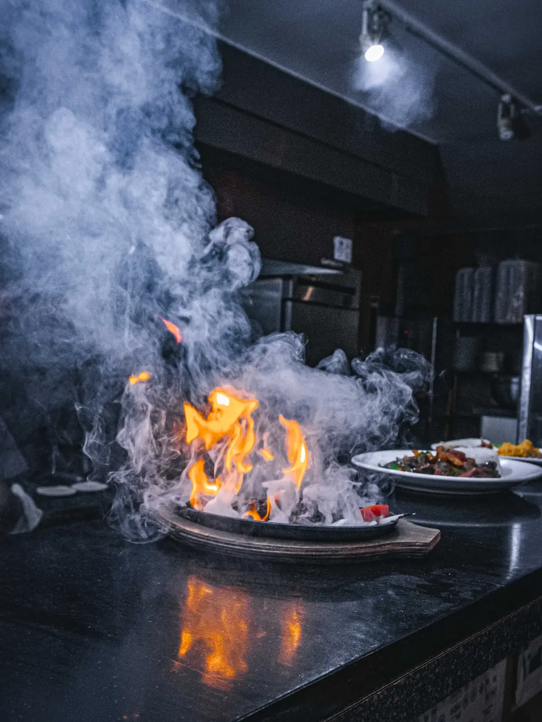 Fajitas flaming on the grill in the kitchen