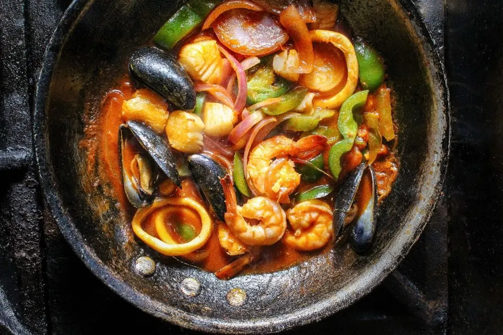 Mariscos saltados in a skillet
